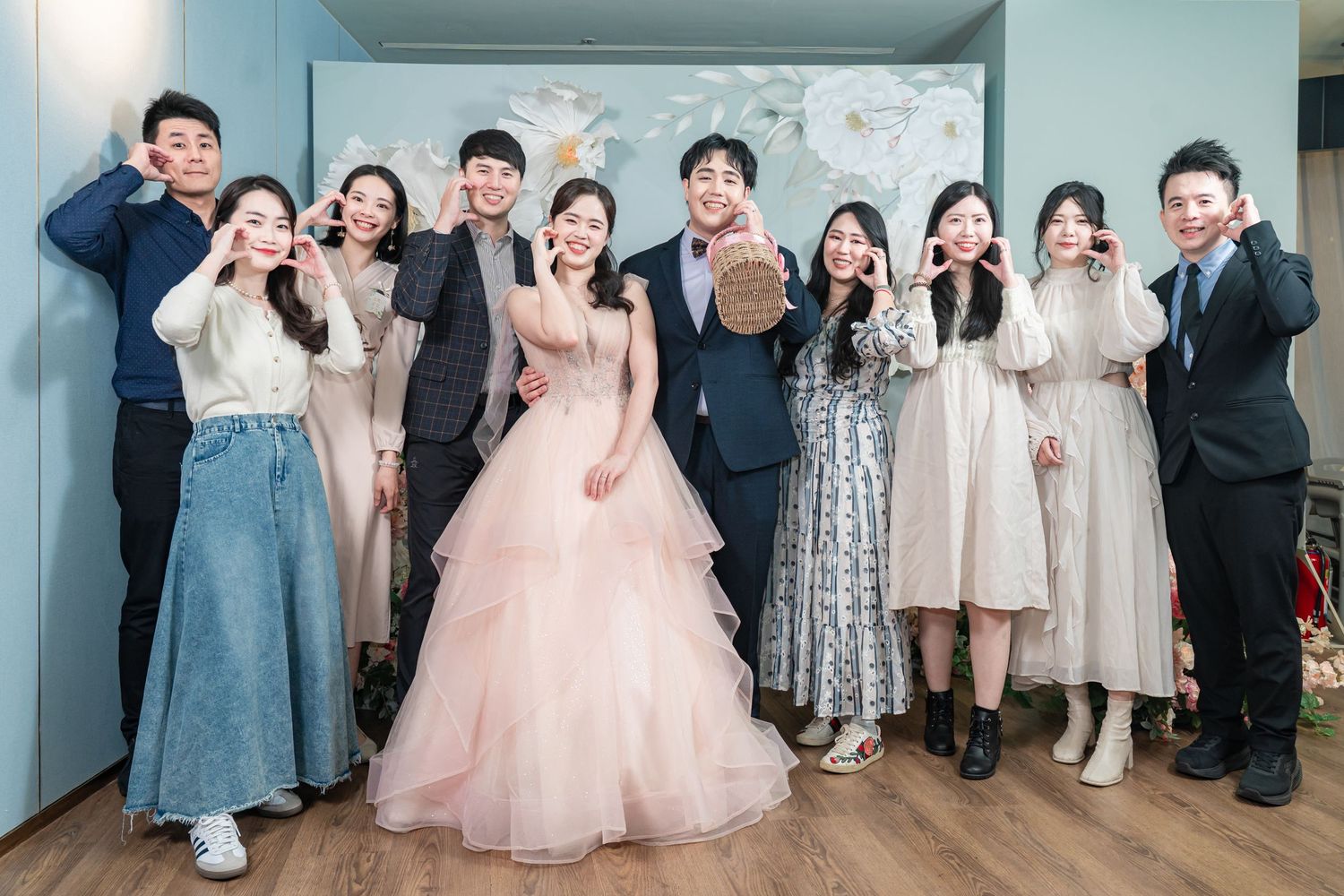 A group of children in formal attire pose together at a special event in a bright hallway.