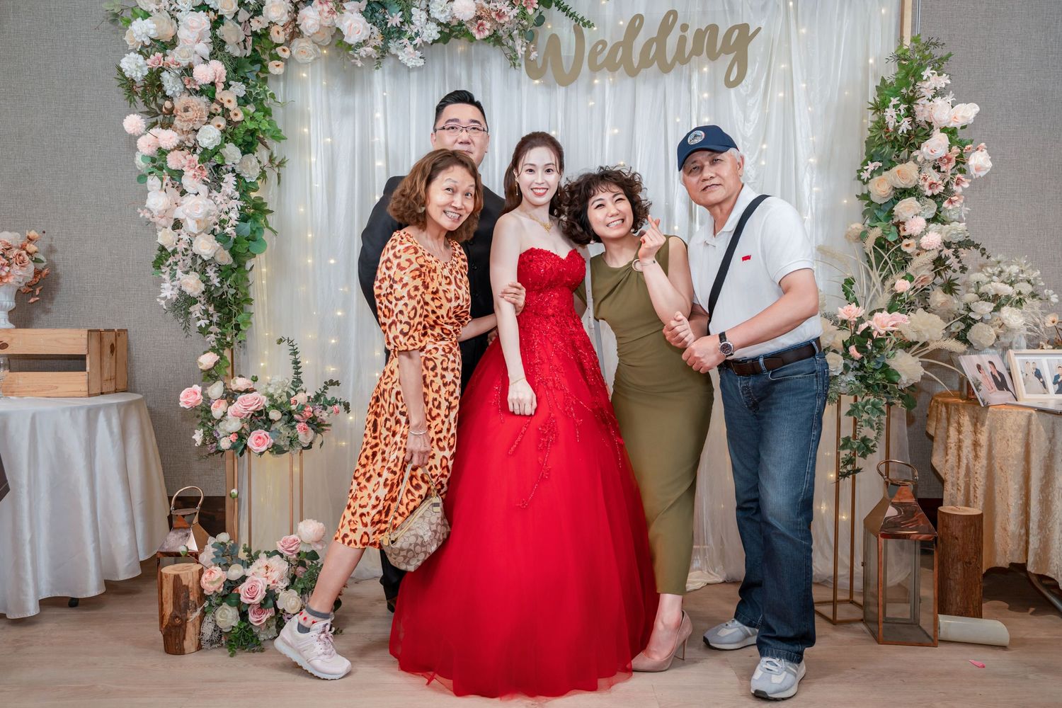A collage of wedding photos featuring floral decorations, a red dress, and romantic moments in an elegant indoor setting.