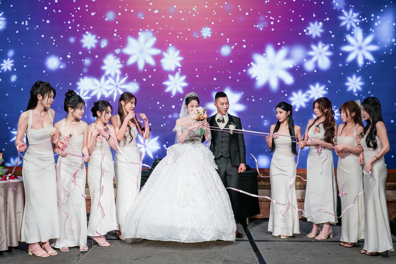 A collage of wedding party photos with bridesmaids in light dresses against a snowy winter background with snowflakes.