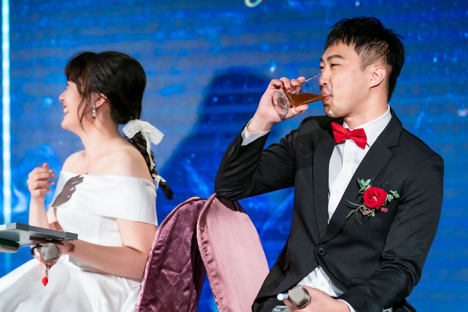 Bride and groom take shots during their wedding reception entertainment.