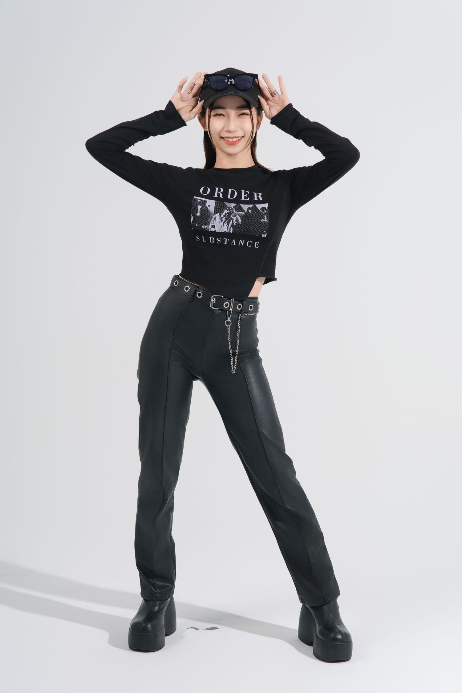 A person in a black outfit and hat strikes dynamic poses against a white background in a fashion photo series.