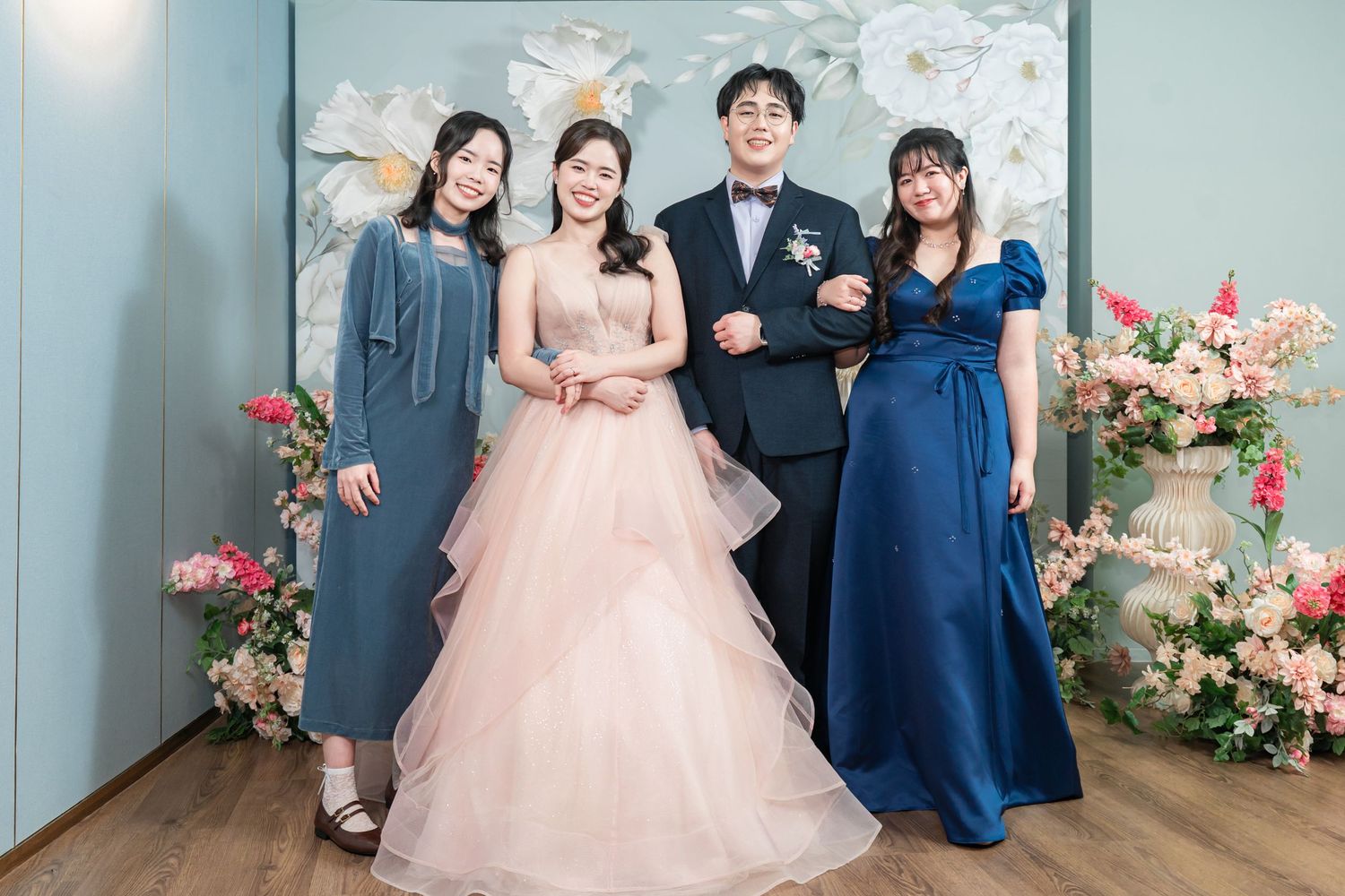 A wedding photo collage showing a couple and guests in formal attire with pink and navy blue color scheme and floral decor.