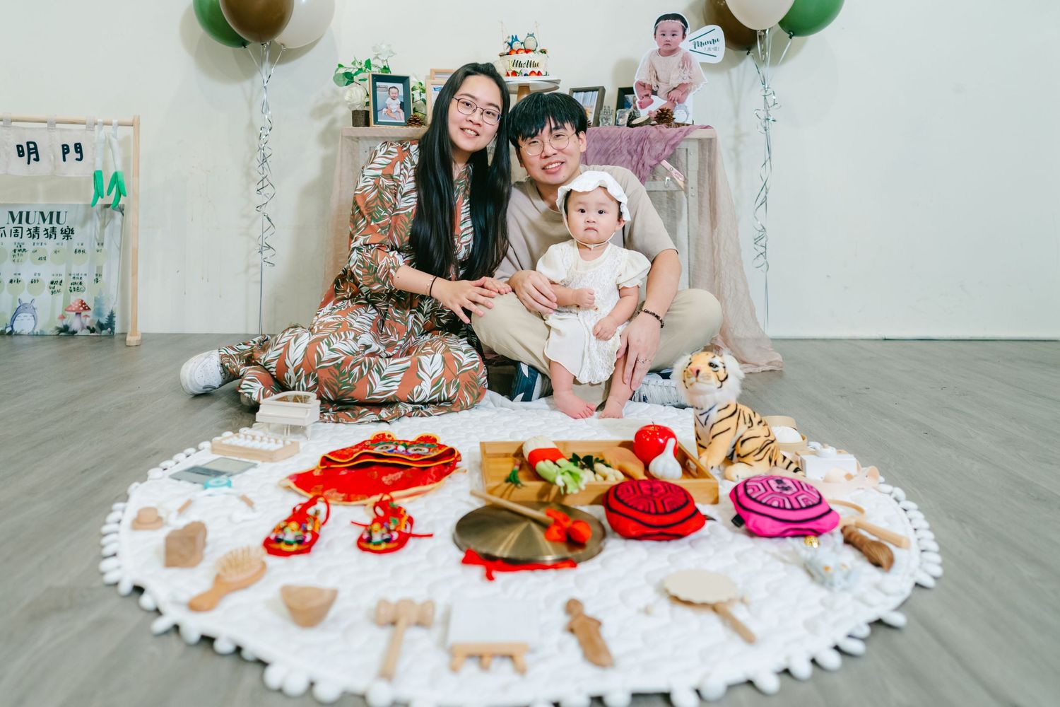 Family celebrates with memorial Christmas display featuring ornaments and decorations on white circle mat.