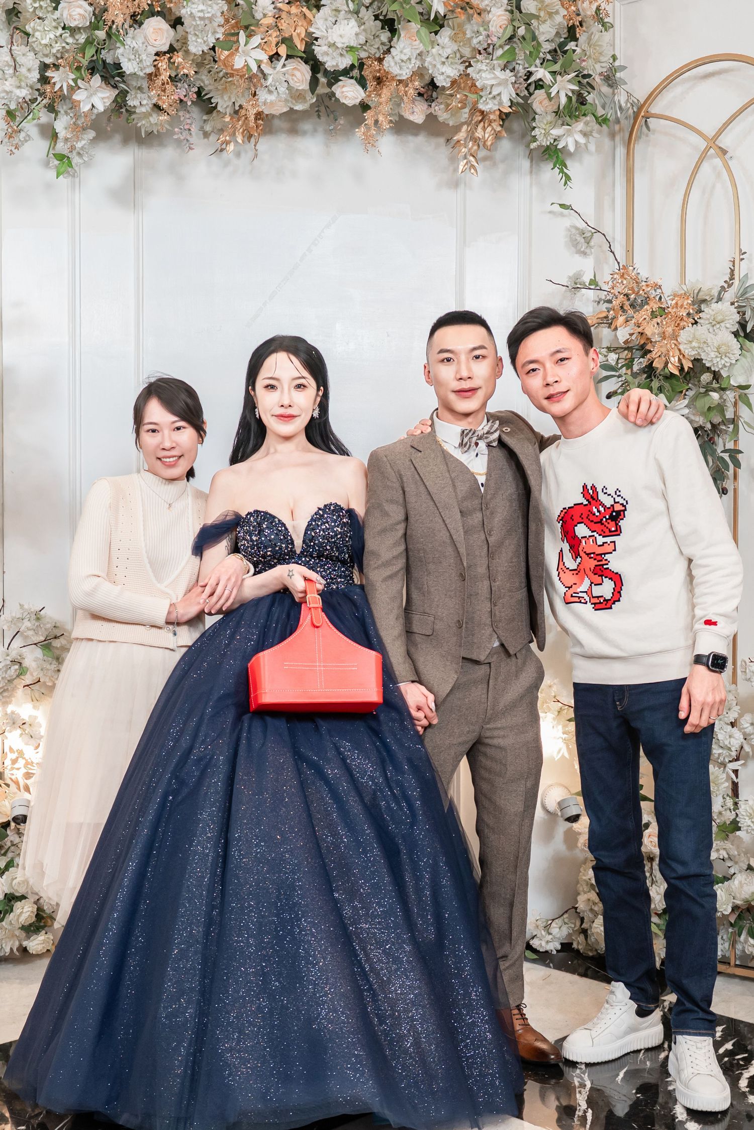 A series of formal family portraits against a floral backdrop with people wearing navy blue dresses and formal attire.