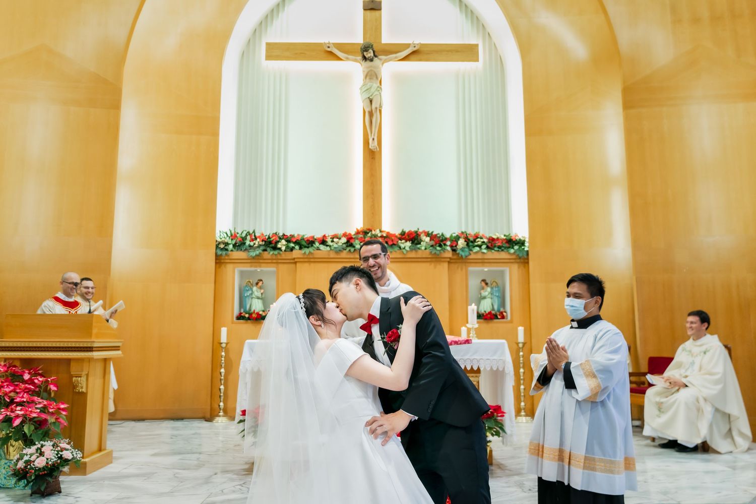 A wedding ceremony moment captured inside a church with ornate decorations and altar.
