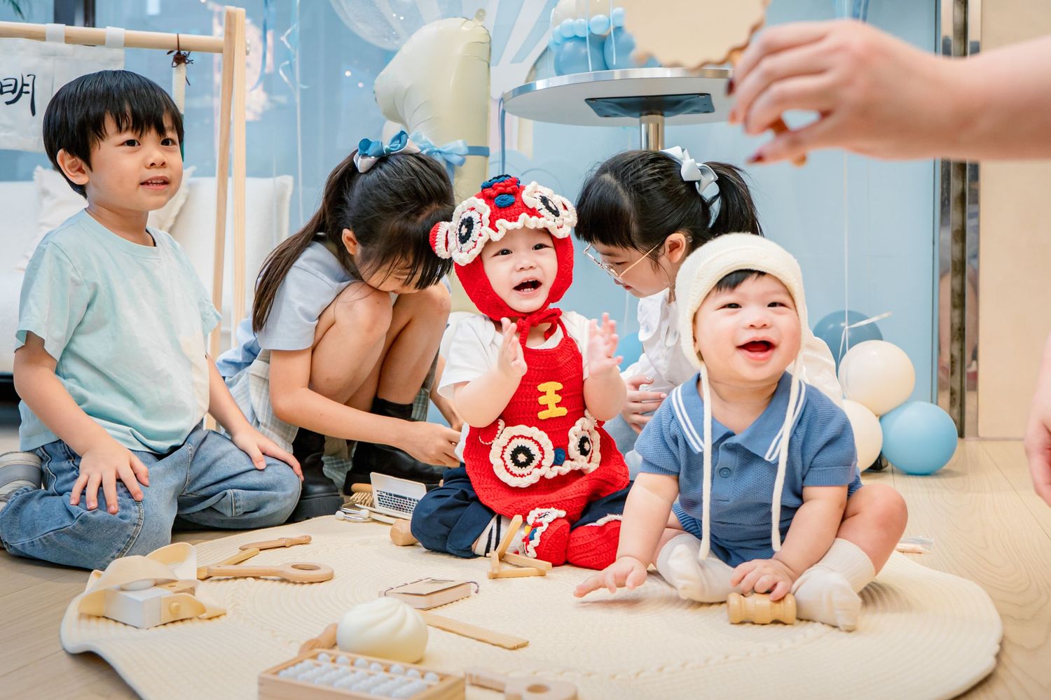 Children play and explore with flour and dough during a fun baking activity in a bright indoor setting.