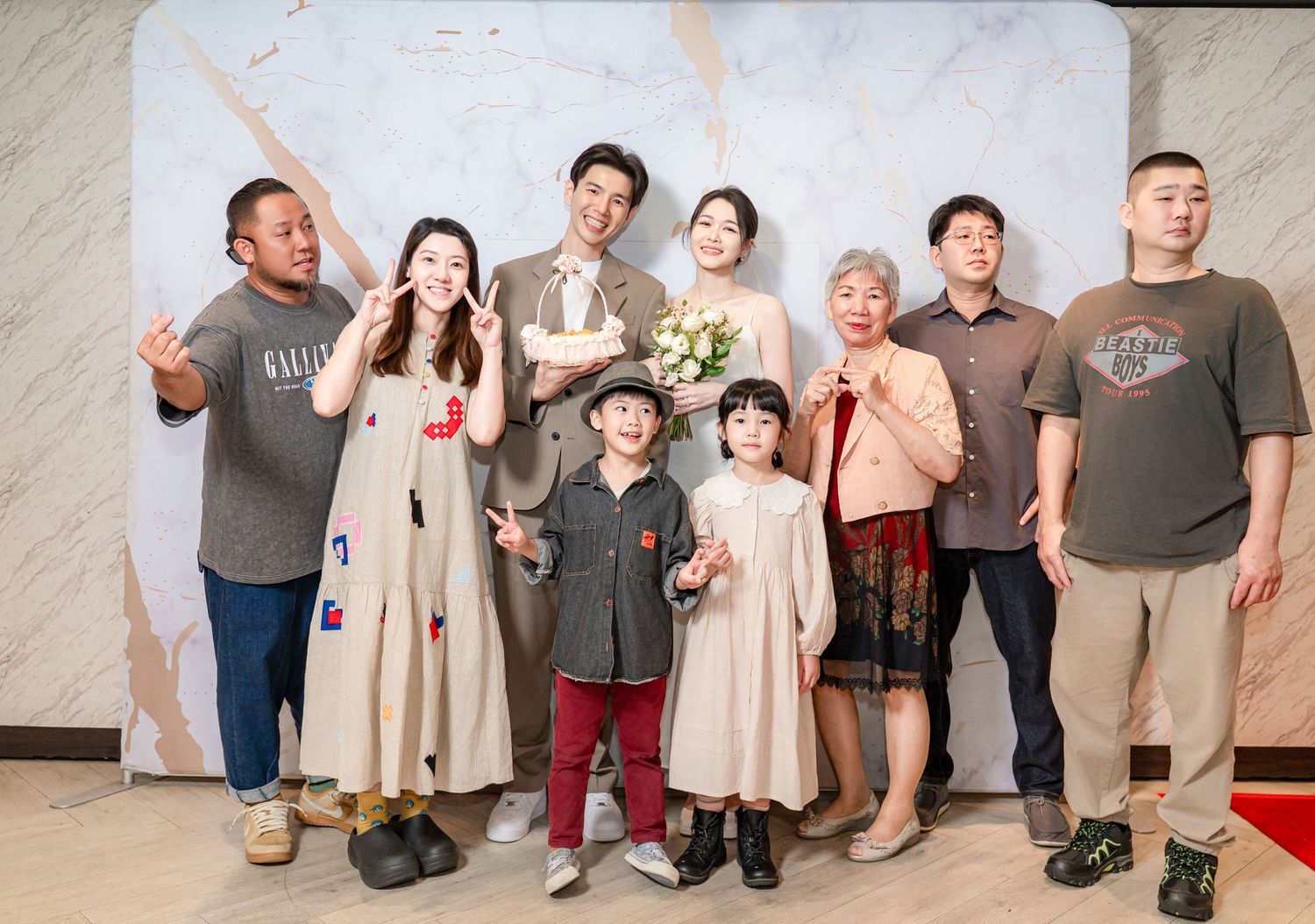 Group photo series showing people posing in casual outfits against a neutral backdrop at a gathering.