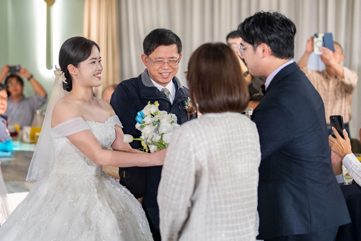 Wedding guests dance and celebrate during a joyful reception party in an elegant venue.