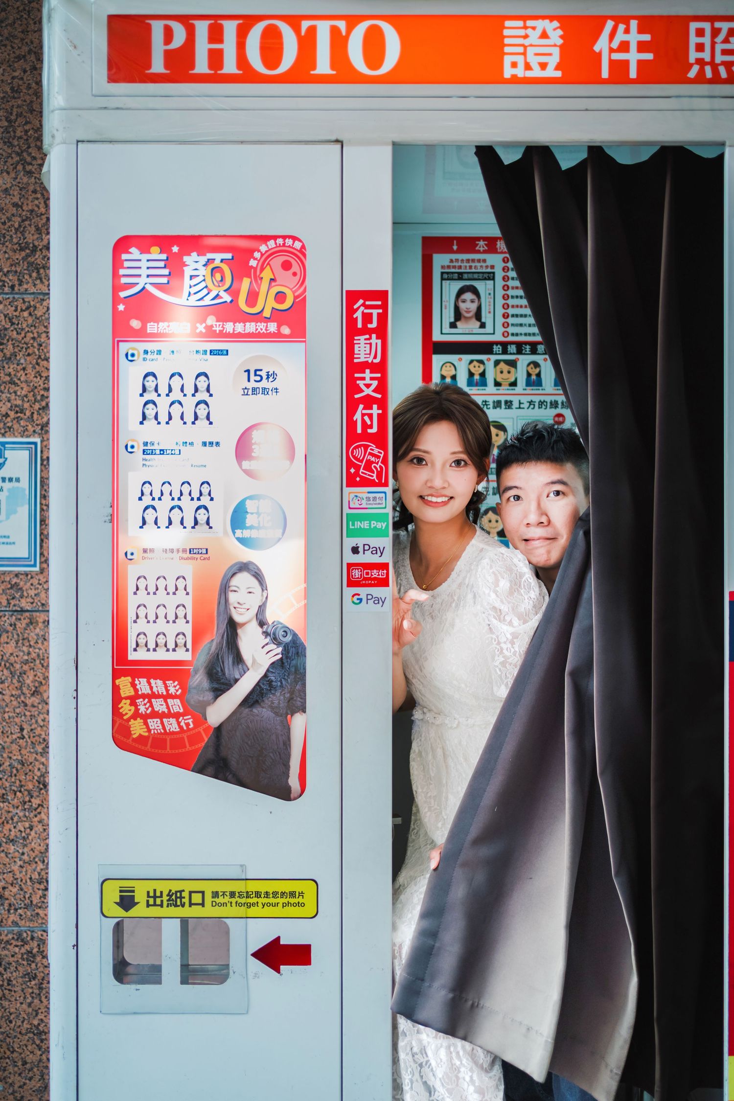 A series of Japanese photo booth machines with signage and advertisements displayed in a row.