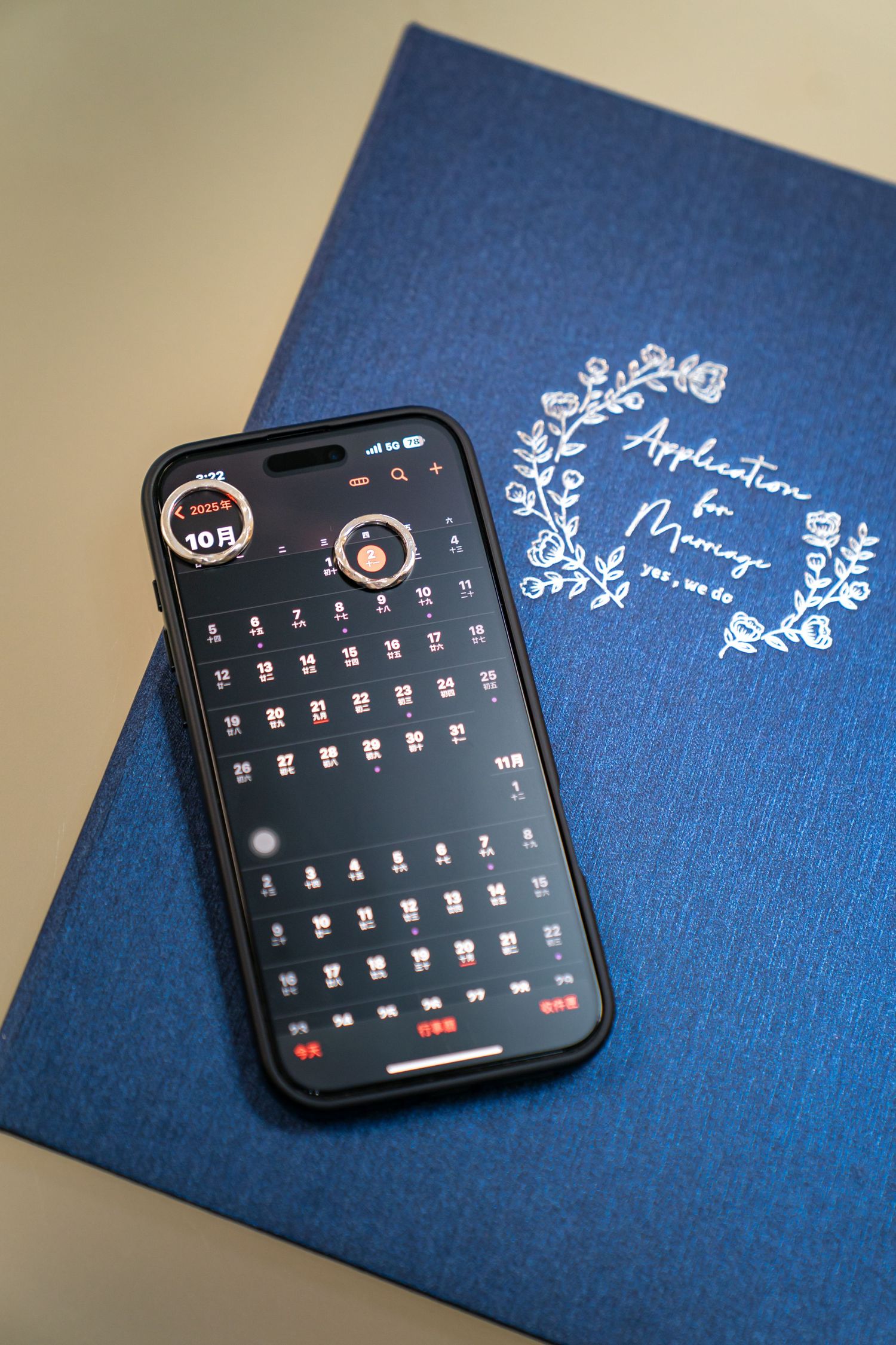 Apple Watch display showing calendar month view on dark screen against blue textured background.