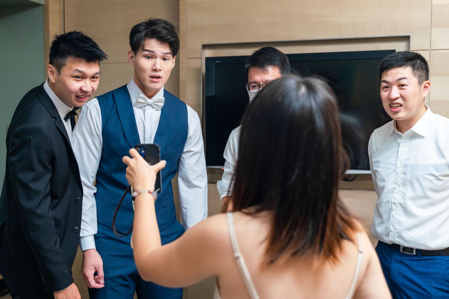 A group of professionals engaged in conversation during a business meeting in an office setting.