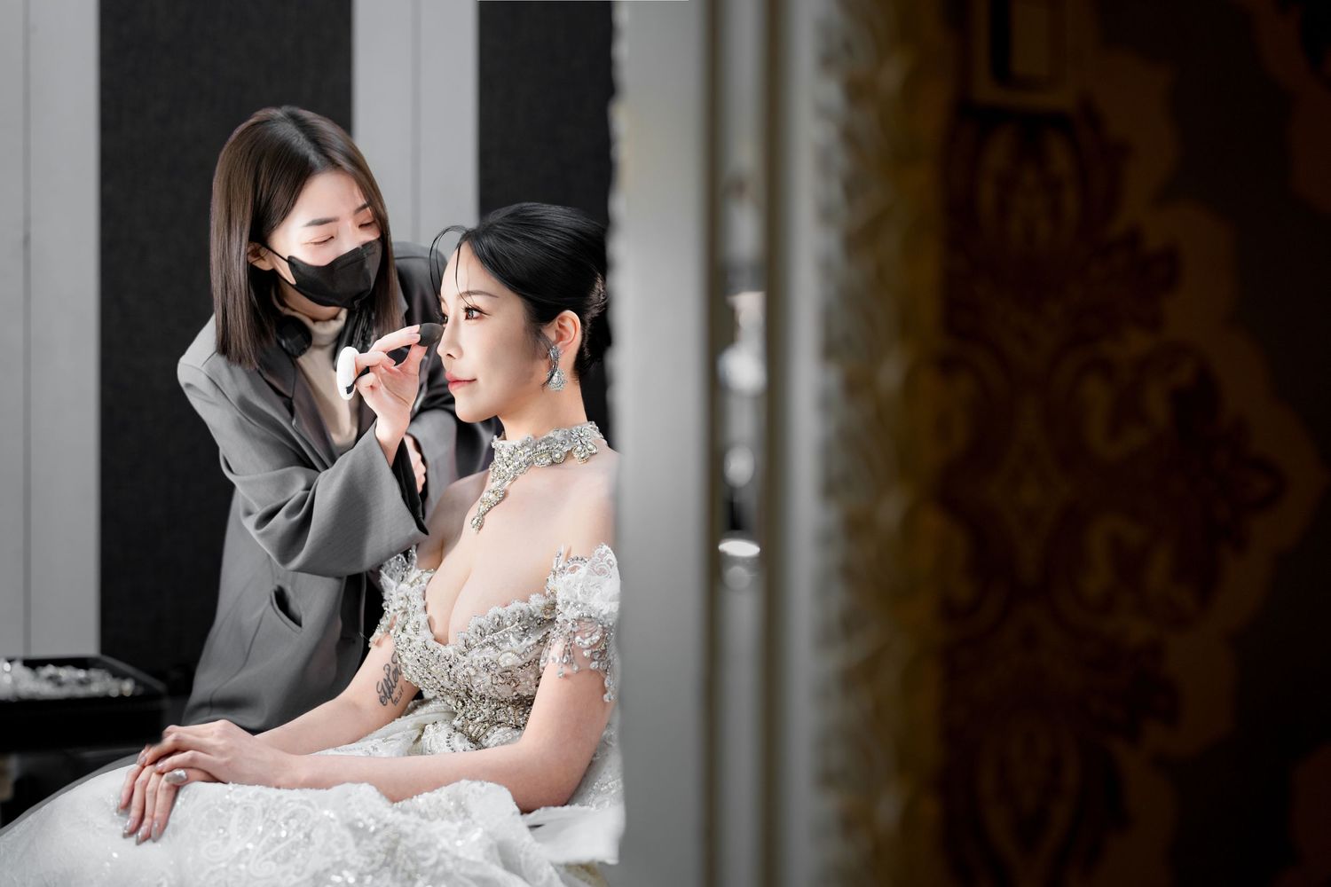 Bride and groom share an intimate moment during their wedding photoshoot in an elegant indoor setting.