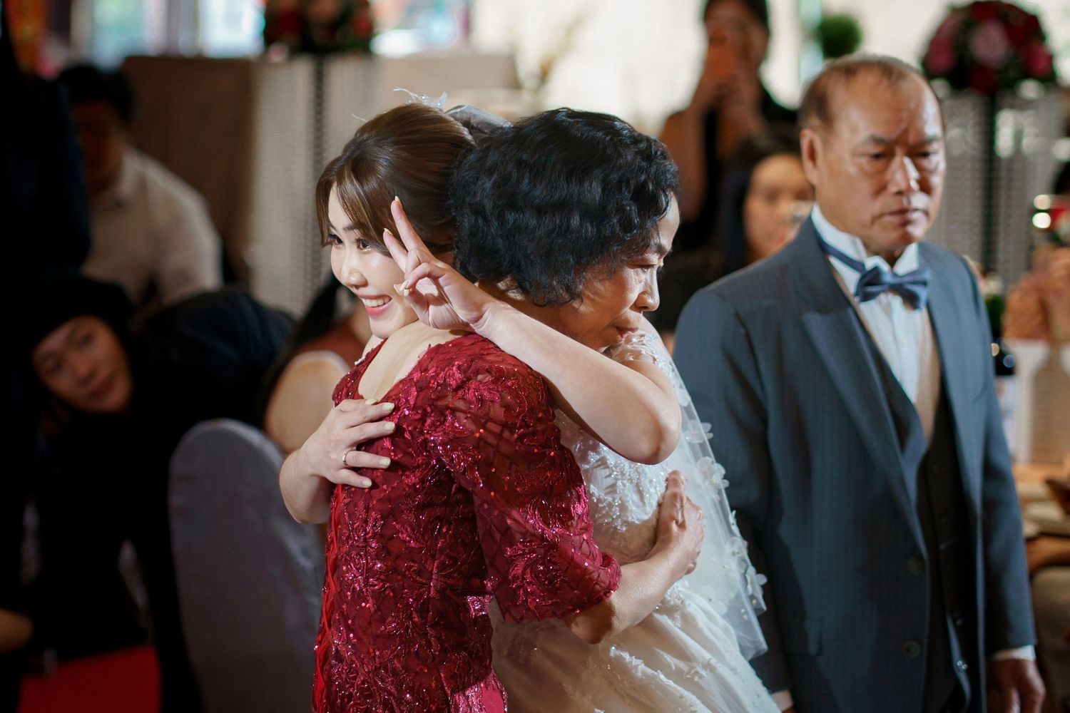 A series of wedding reception photos showing emotional moments between guests during dancing and celebrations.