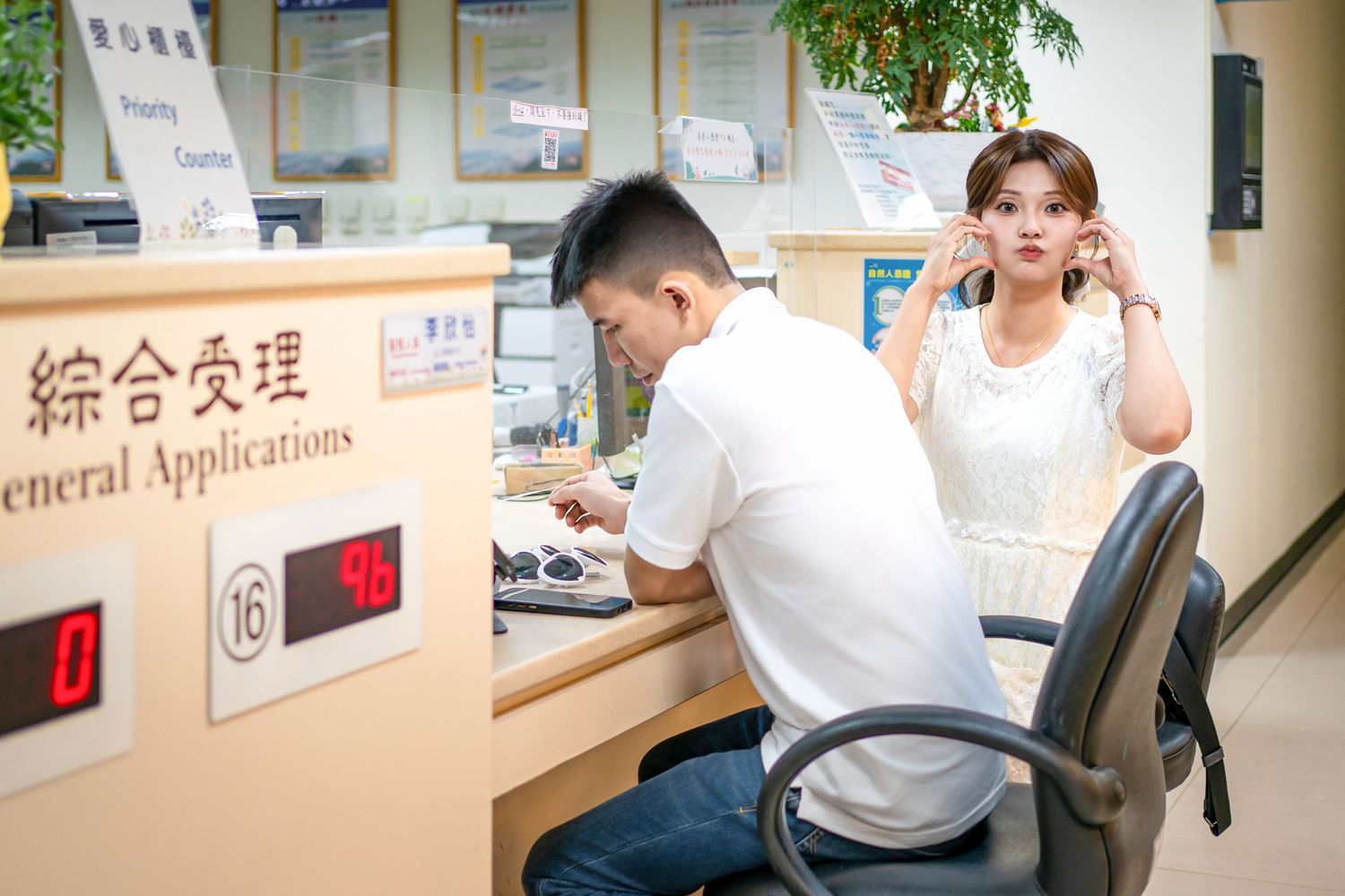 Students work at individual stations in a modern office setting with multiple computer workstations and signage.
