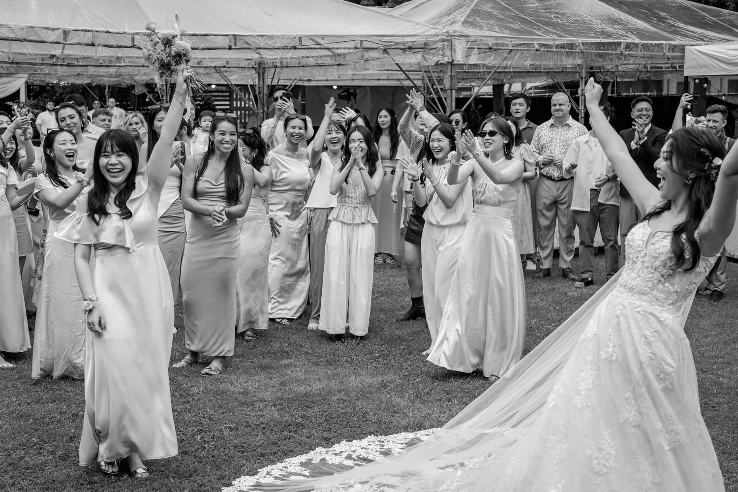 Bride tosses bouquet to excited bridesmaids in white gowns at outdoor wedding reception in black and white photo.

台北婚禮攝影
婚禮攝影師
戶外婚禮
婚禮紀實
婚攝