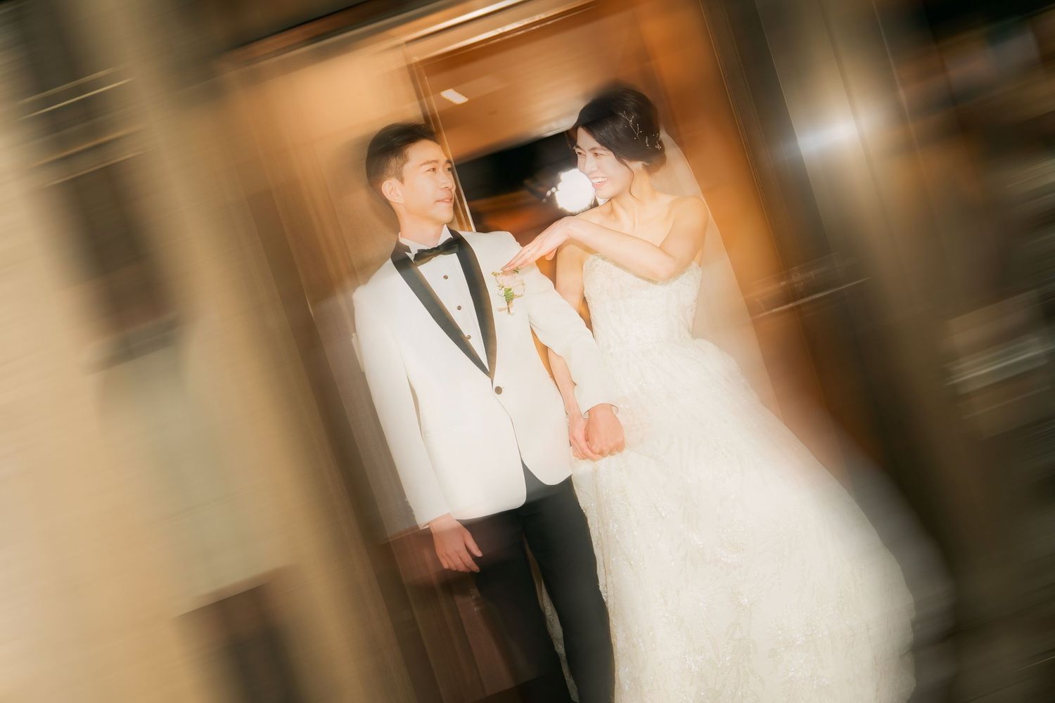 Artistic blurred motion photograph of a bride and groom dancing together at their wedding reception.