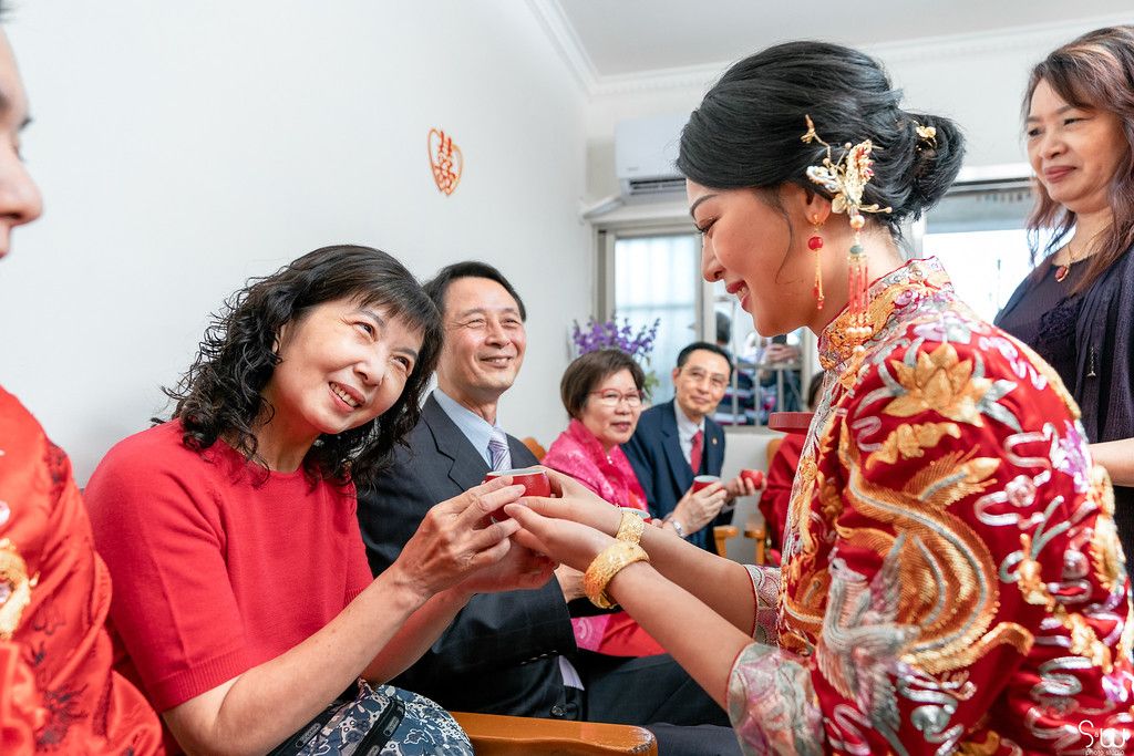 Tea ceremony participants share happy moment during traditional Chinese wedding customs.