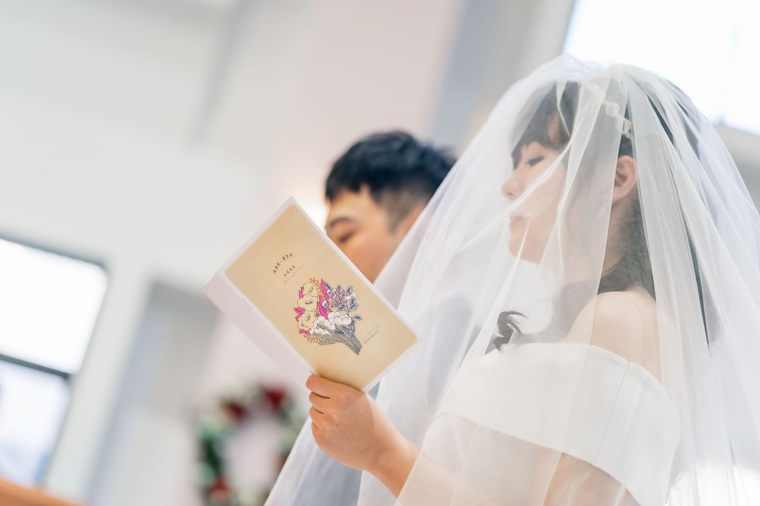 Couple participates in wedding ceremony while reading from service booklets.