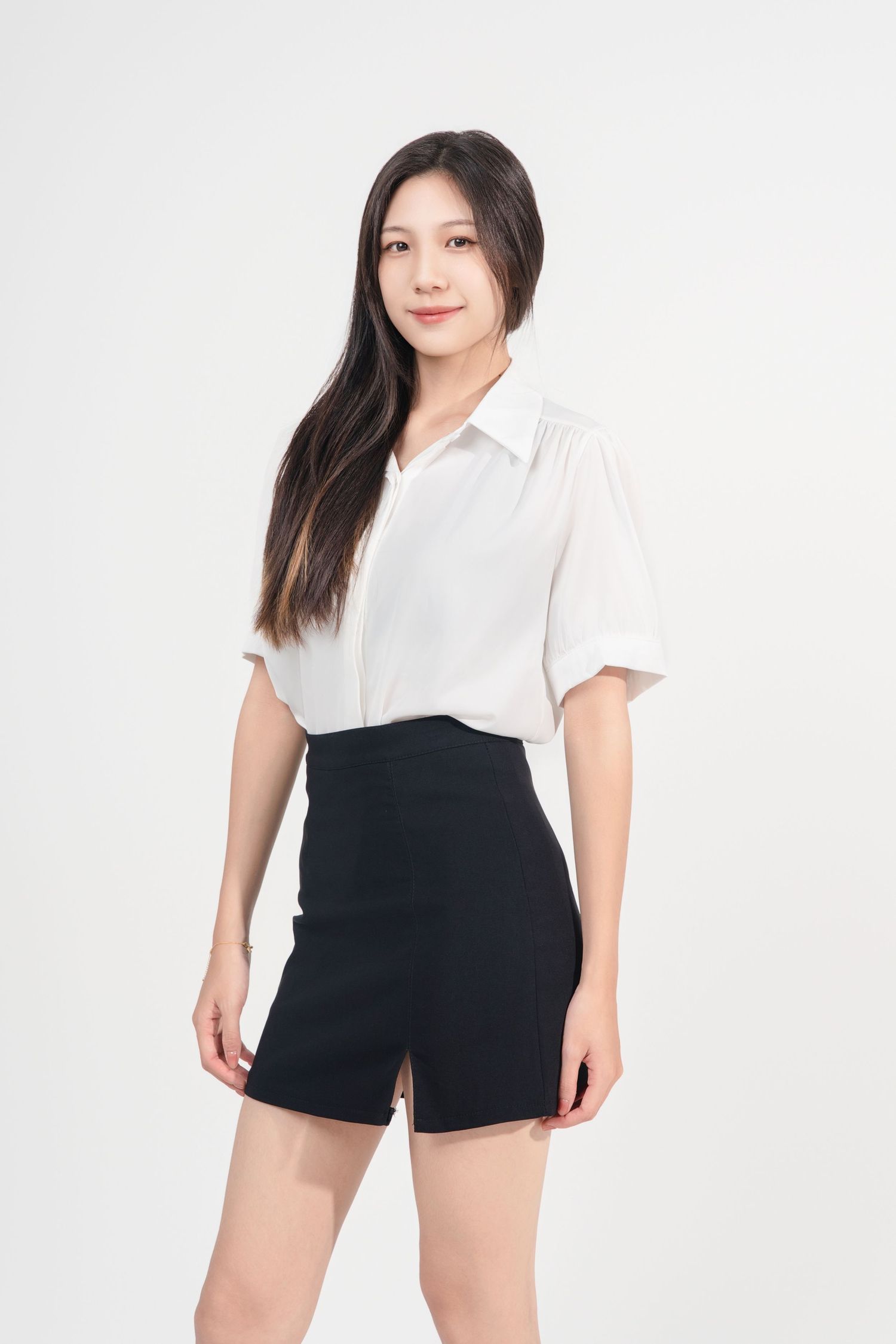Woman wearing a black and white two-tone romper poses in three different positions against a light background.