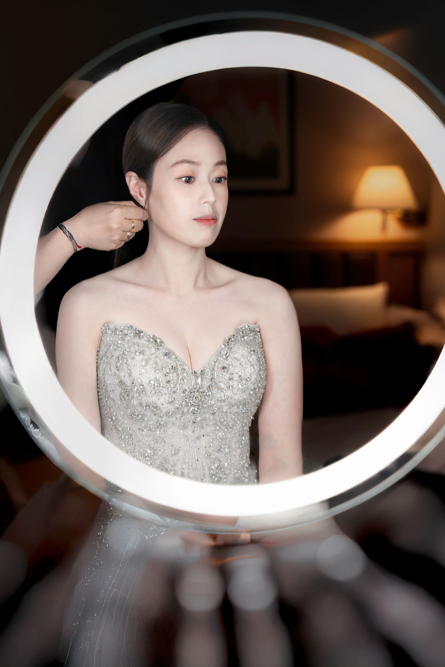 A sequence of elegant portraits showing a person in a silver beaded evening gown against a dark background.