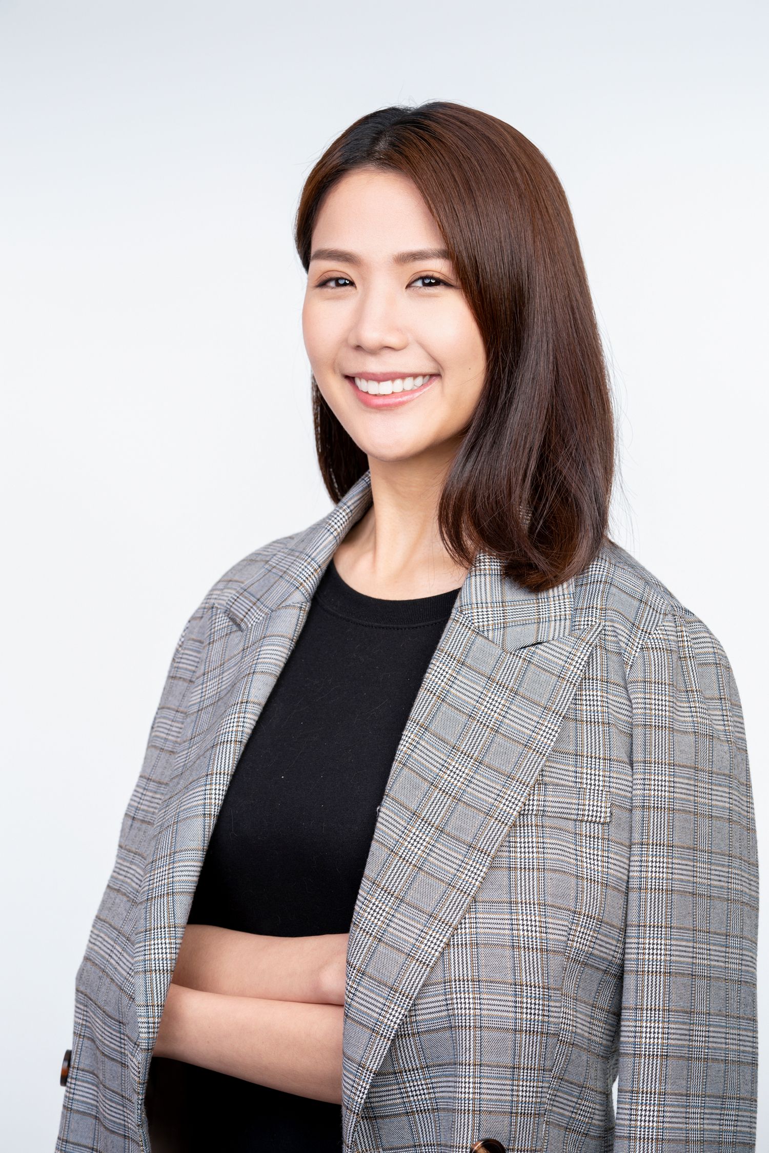 Professional portrait series showing person in gray plaid blazer and black top against white background.