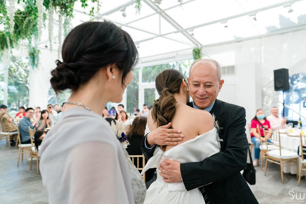 Emotional moment during wedding reception with warm embraces.