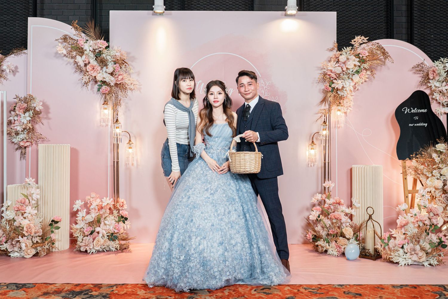 Elegant wedding reception venue decorated with soft pink floral arrangements and romantic lighting.