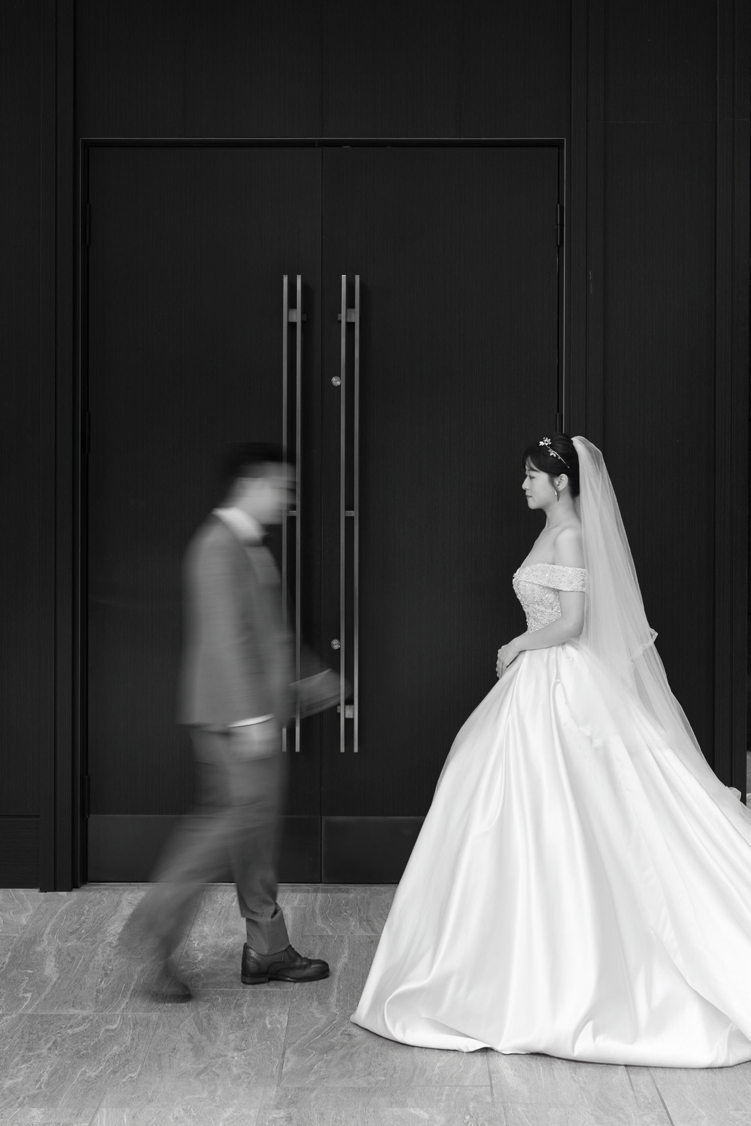 A sequence of black and white photos showing a flowing white wedding dress moving across a dark background.