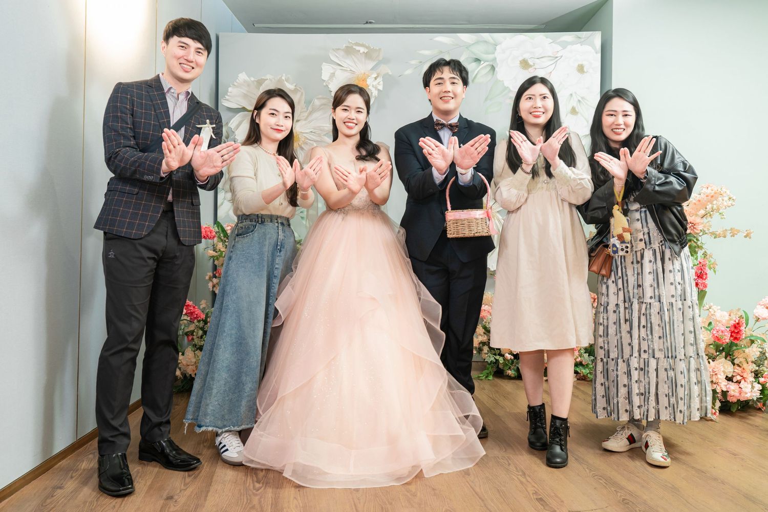 A series of wedding photos showing a couple and guests celebrating in formal attire at an indoor venue.