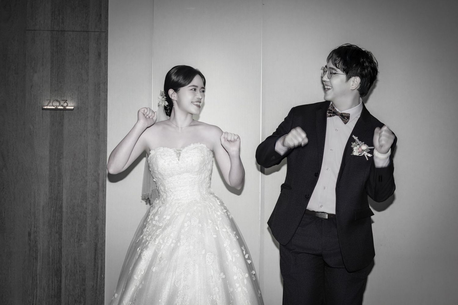 A series of black and white wedding photos showing a couple dancing and celebrating together in formal attire.