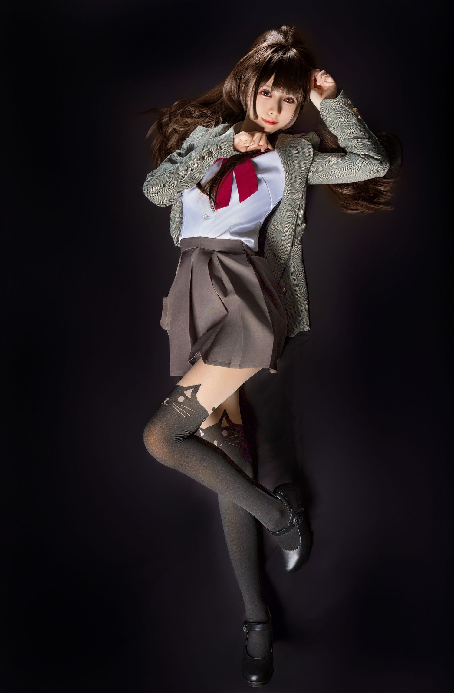 Japanese school uniform cosplay costume shown in dynamic jumping pose against dark background with gray blazer and skirt.