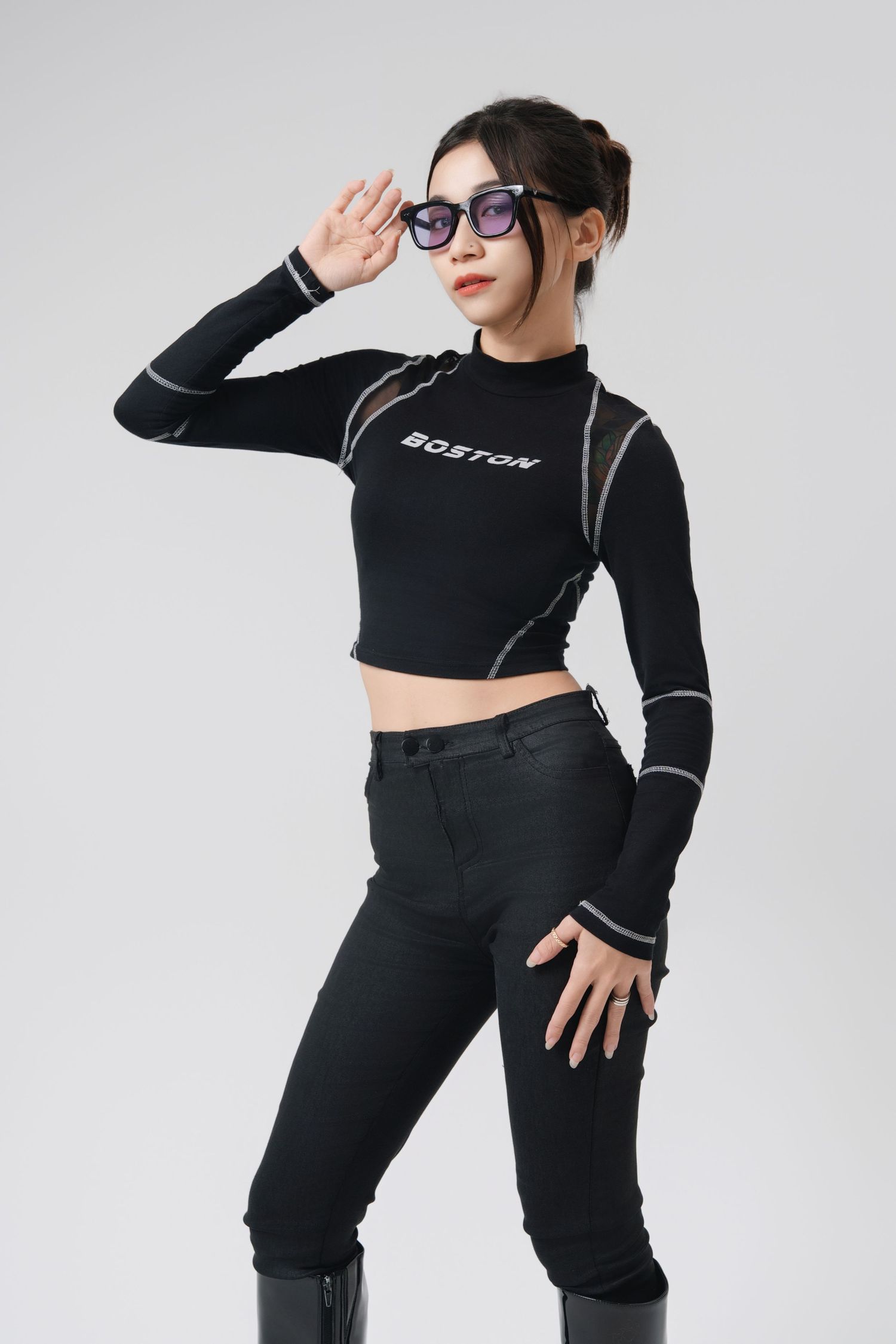 Person in black activewear strikes dynamic poses against white background wearing sunglasses and sporty outfit.