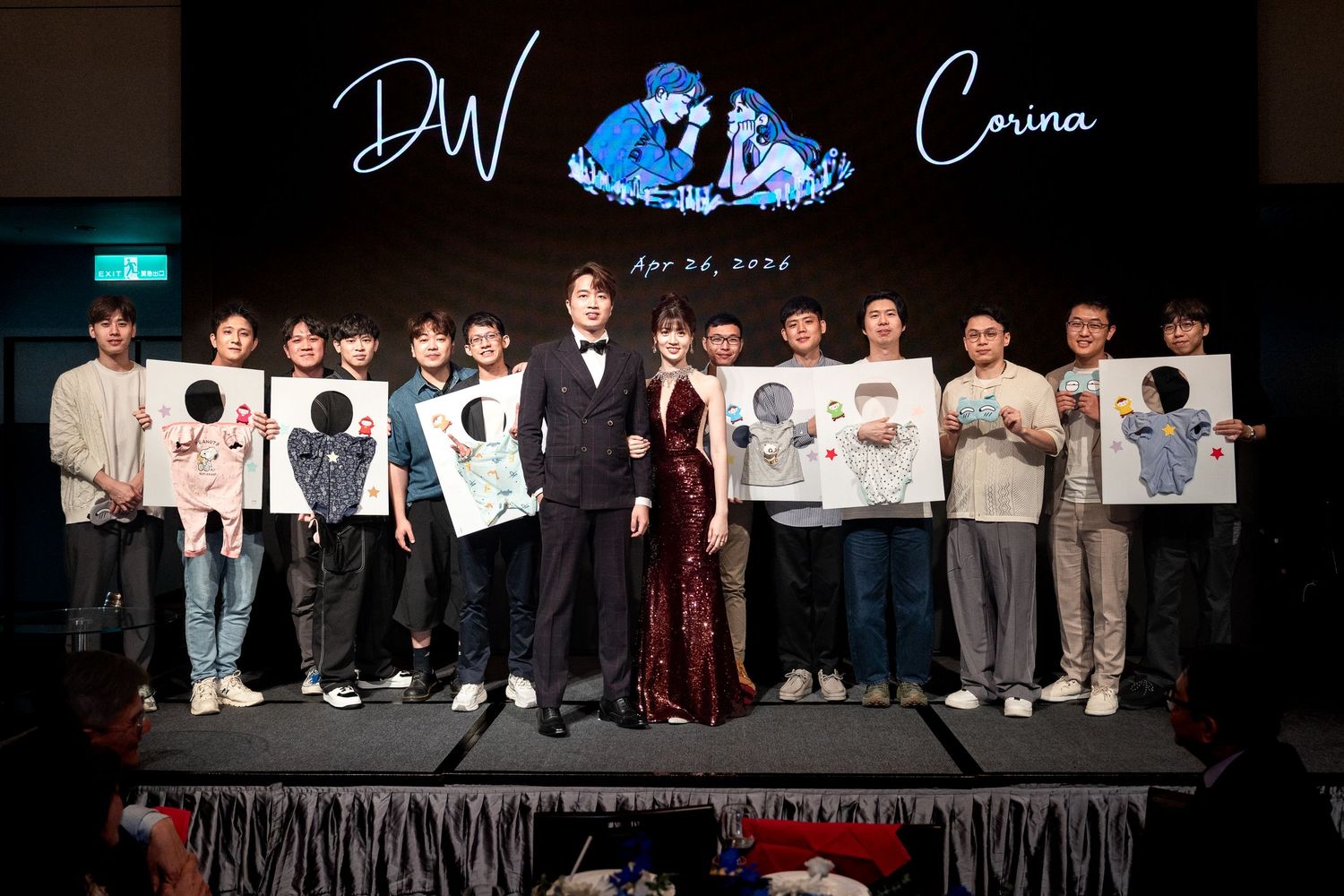 Group photo of elegantly dressed people holding artwork at a DW and Carina event on Apr 04, 2023.