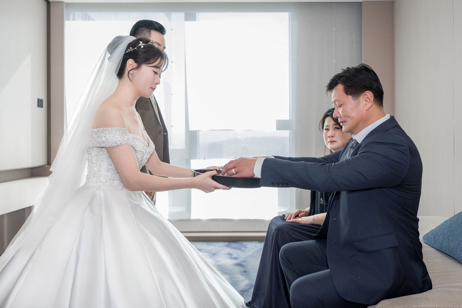 Collage of wedding day moments showing couple exchanging rings in a bright, modern hotel room setting.