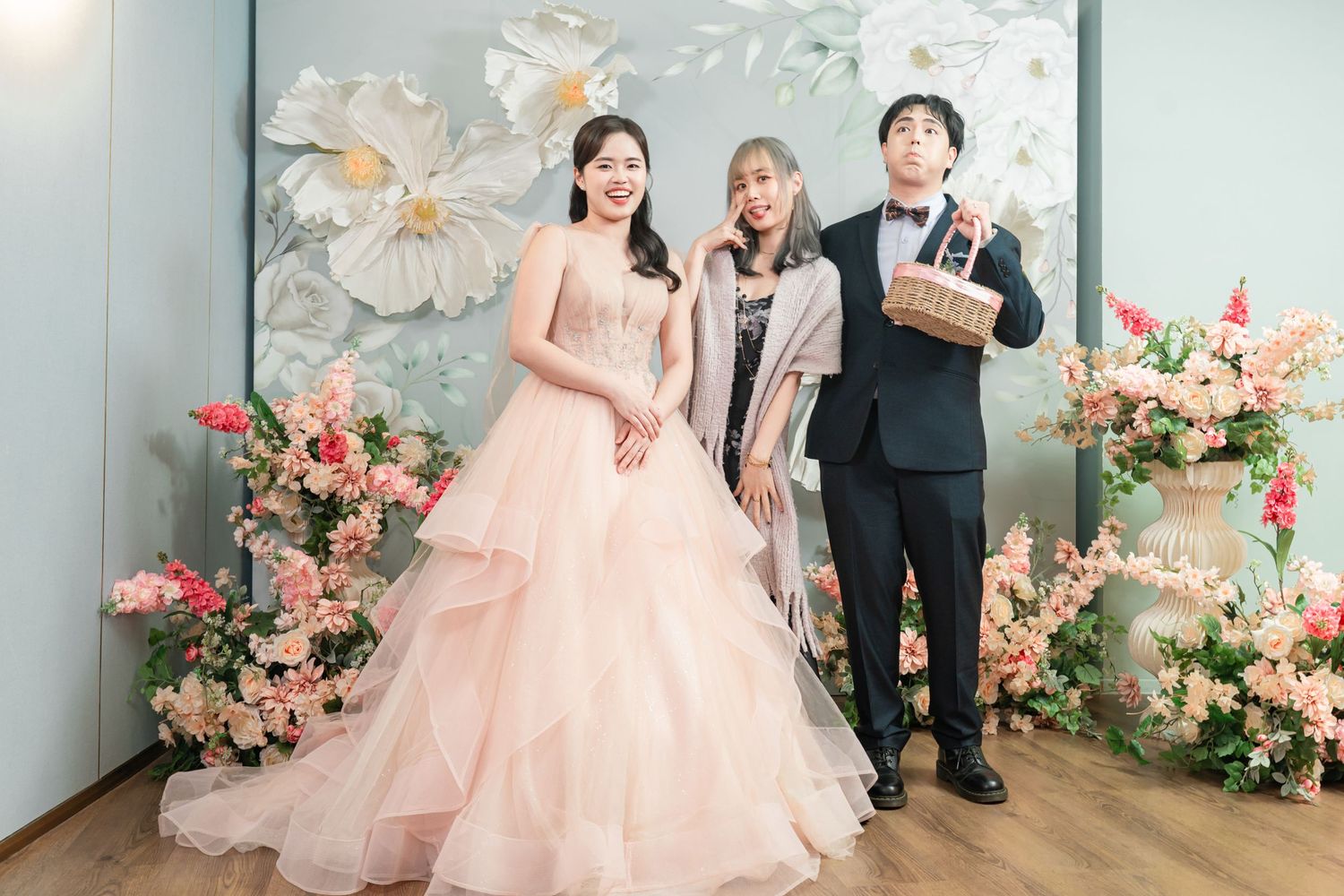 A romantic wedding scene with pink floral decor and tulle gown details captured in multiple elegant photos.