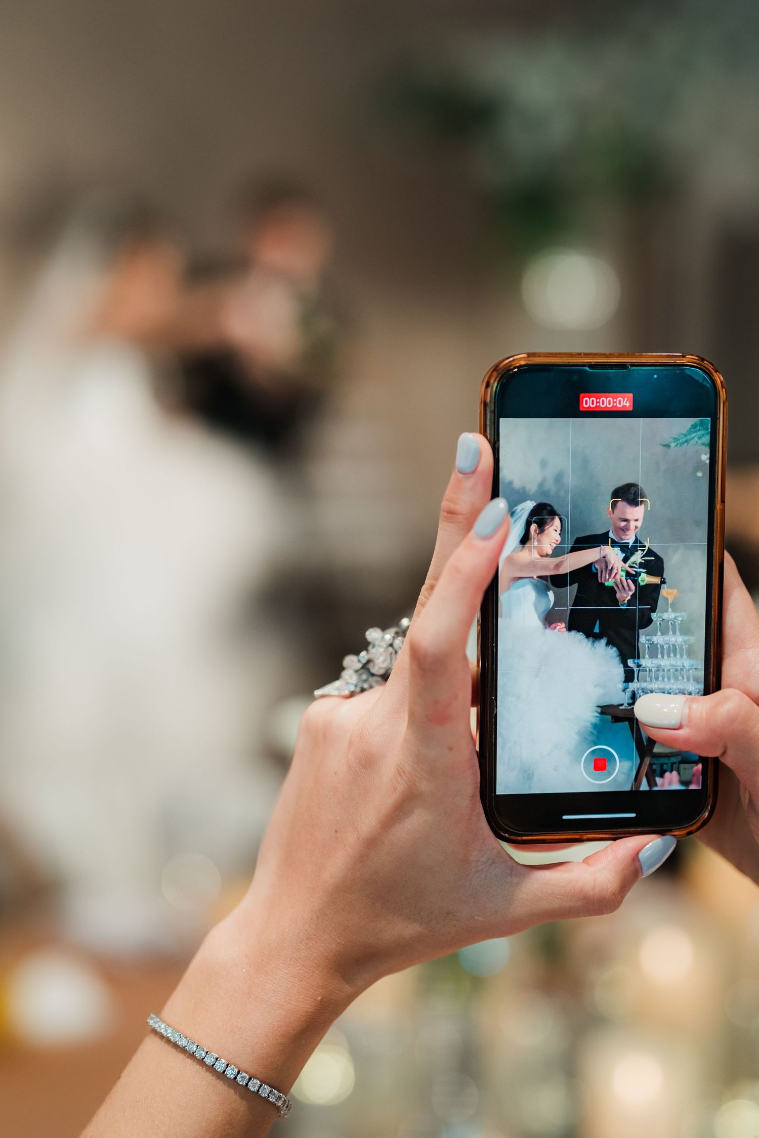 Hand holding smartphone displaying Netflix video streaming content with blurred background in horizontal scrolling view.