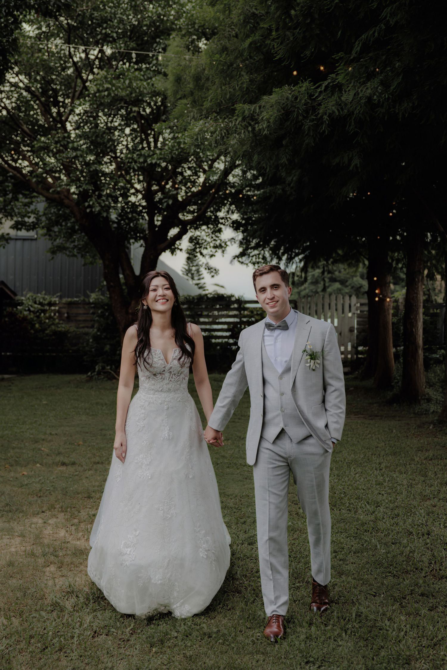 Bride in white gown and groom in gray suit hold hands smiling outdoors at a garden wedding ceremony.台北婚禮攝影
婚禮攝影師
戶外婚禮
婚禮紀實
婚攝推薦
台灣婚禮攝影
自然風格婚