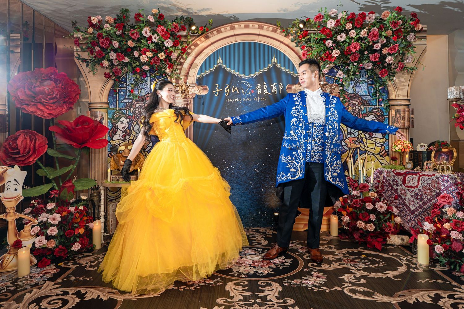 Couple dressed as Beauty and the Beast dancing at a floral-decorated event with roses and elegant backdrop.
