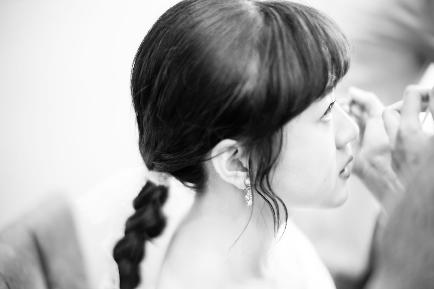 Black and white side profile showing elegant braided hairstyle.