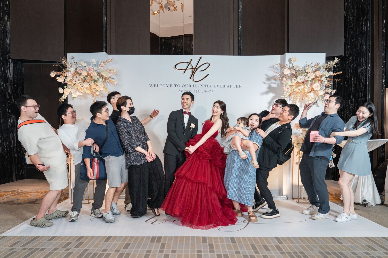 Wedding party performs synchronized dance moves in a coordinated line at reception venue.