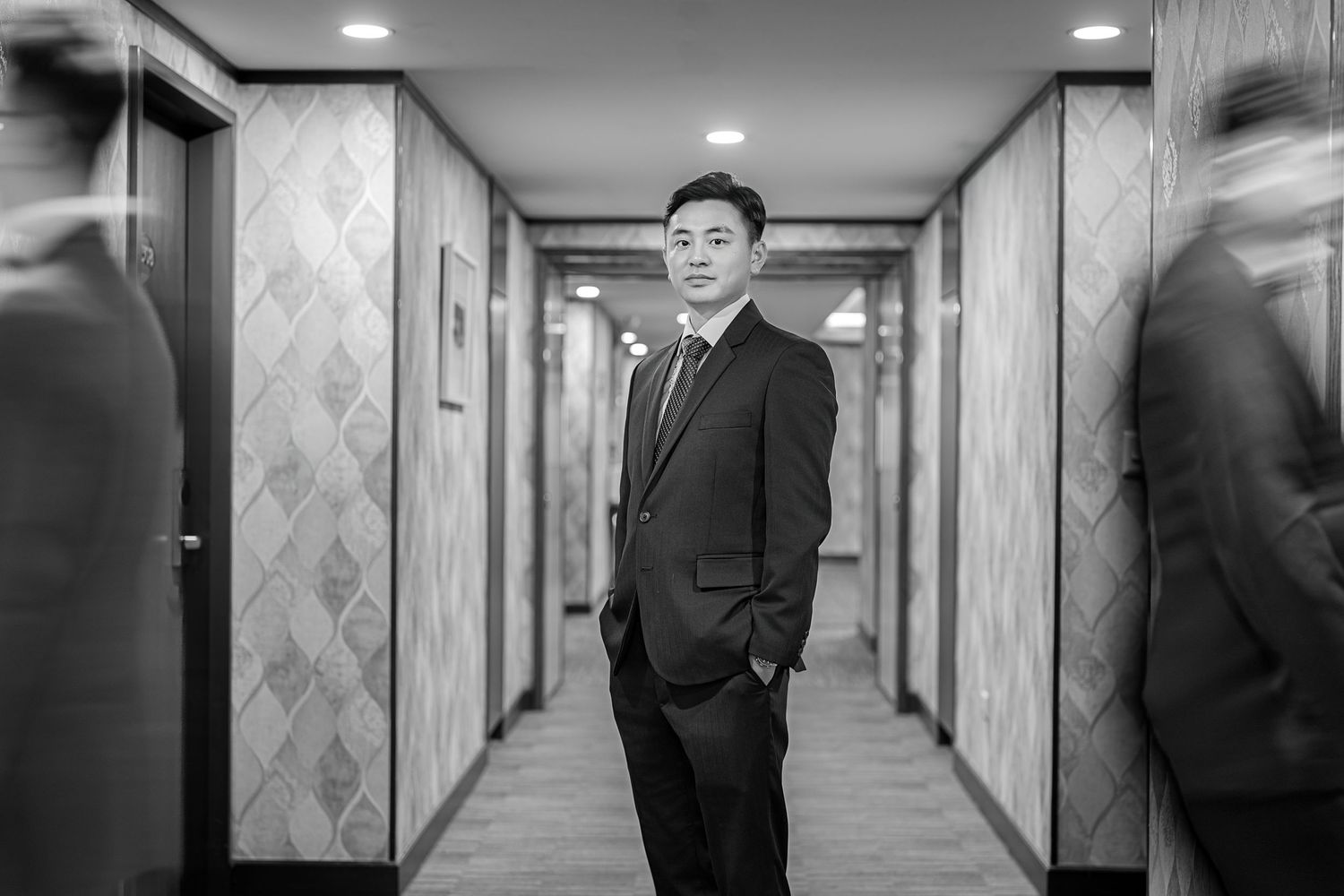 Monochromatic corridor series featuring a suited figure in various dramatic poses against geometric walls.