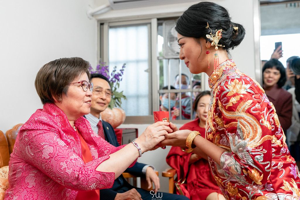 Traditional tea ceremony showing respect between family members during Chinese wedding.