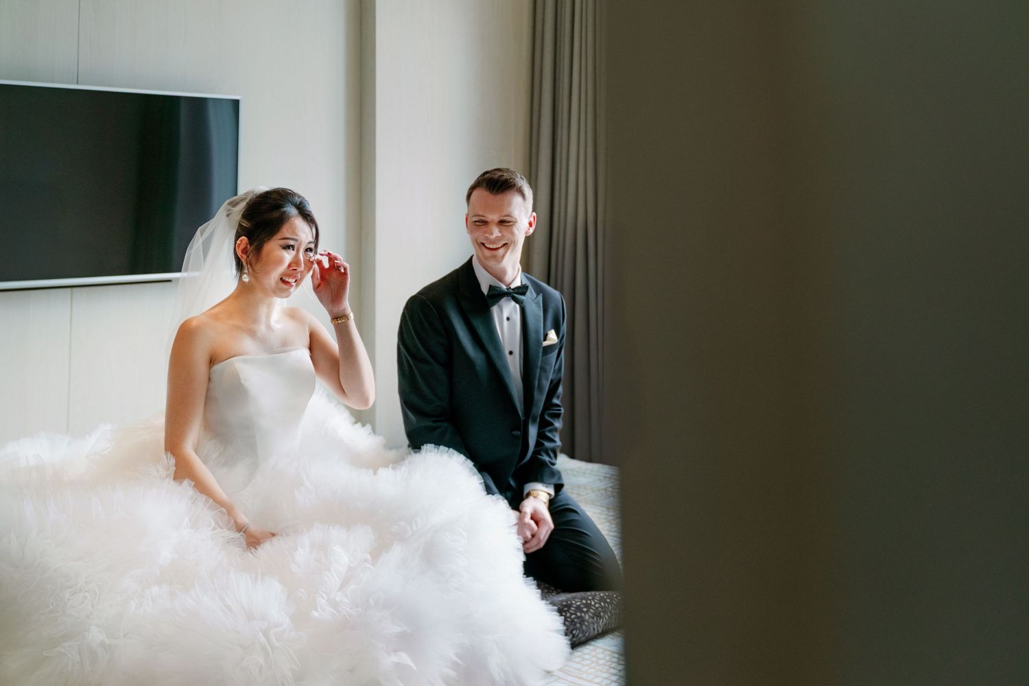 A couple shares a quiet moment together in an elegant room during their wedding celebration.