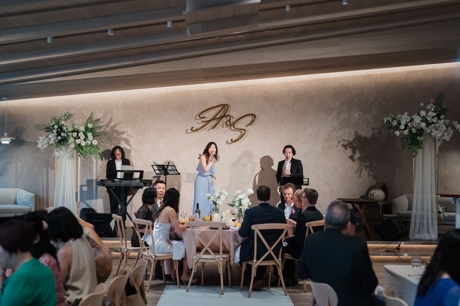 A sequence of photos showing a wedding reception in a modern indoor venue with elegant decor and dining setup.