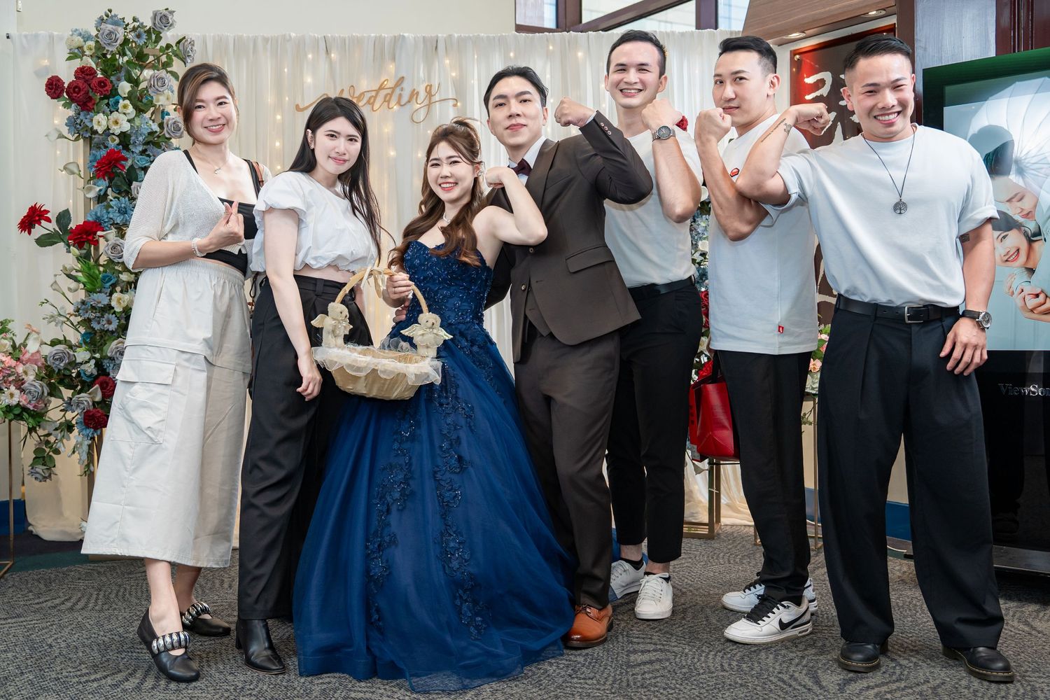 Wedding party members laugh and dance together in a joyful celebration scene.