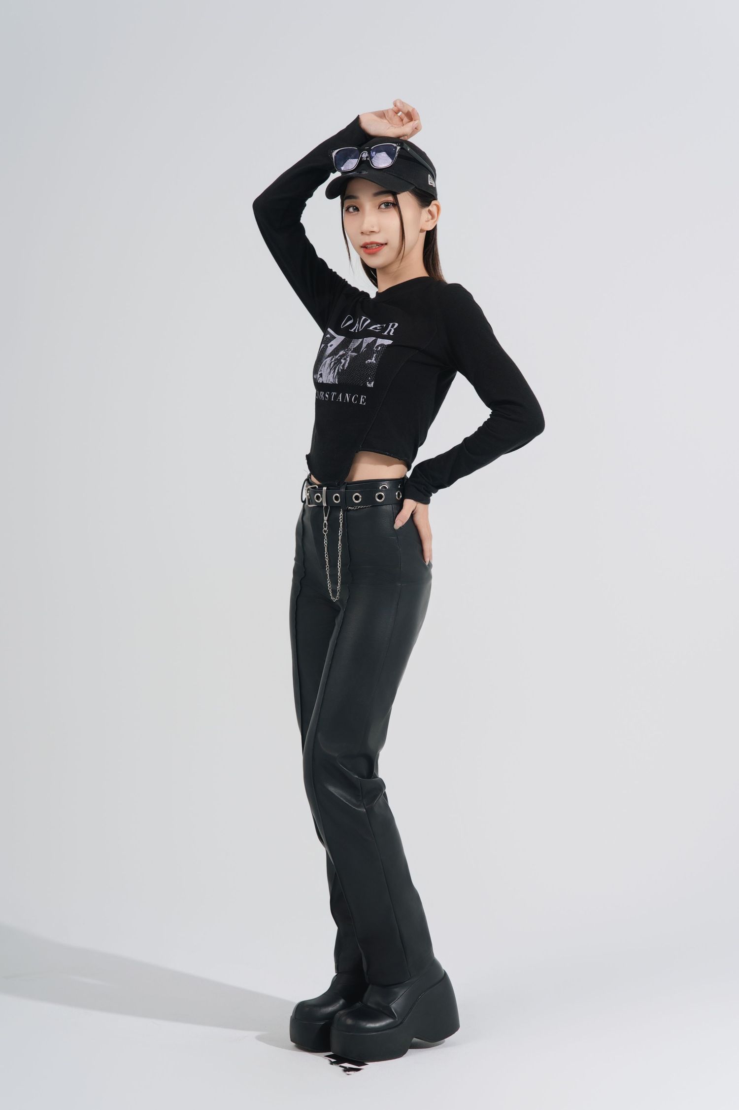A figure in all black streetwear poses dynamically against a white background in a series of fashion shots.