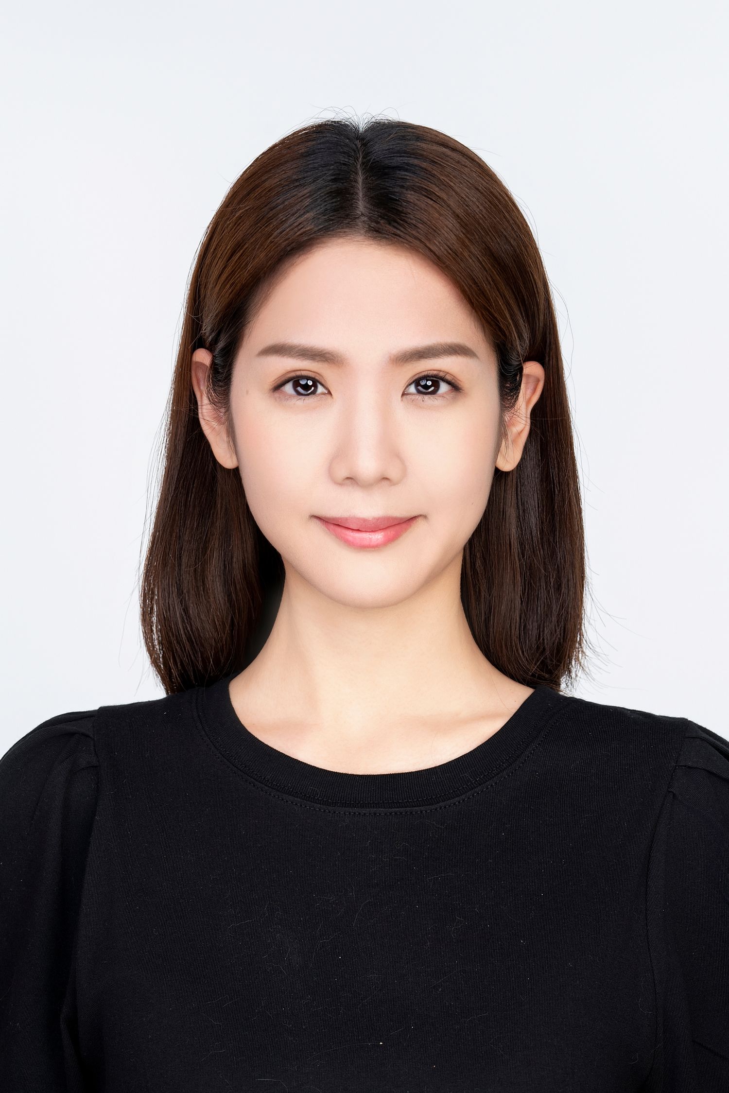 Professional headshot portrait of someone wearing a black sweater against a white background.
