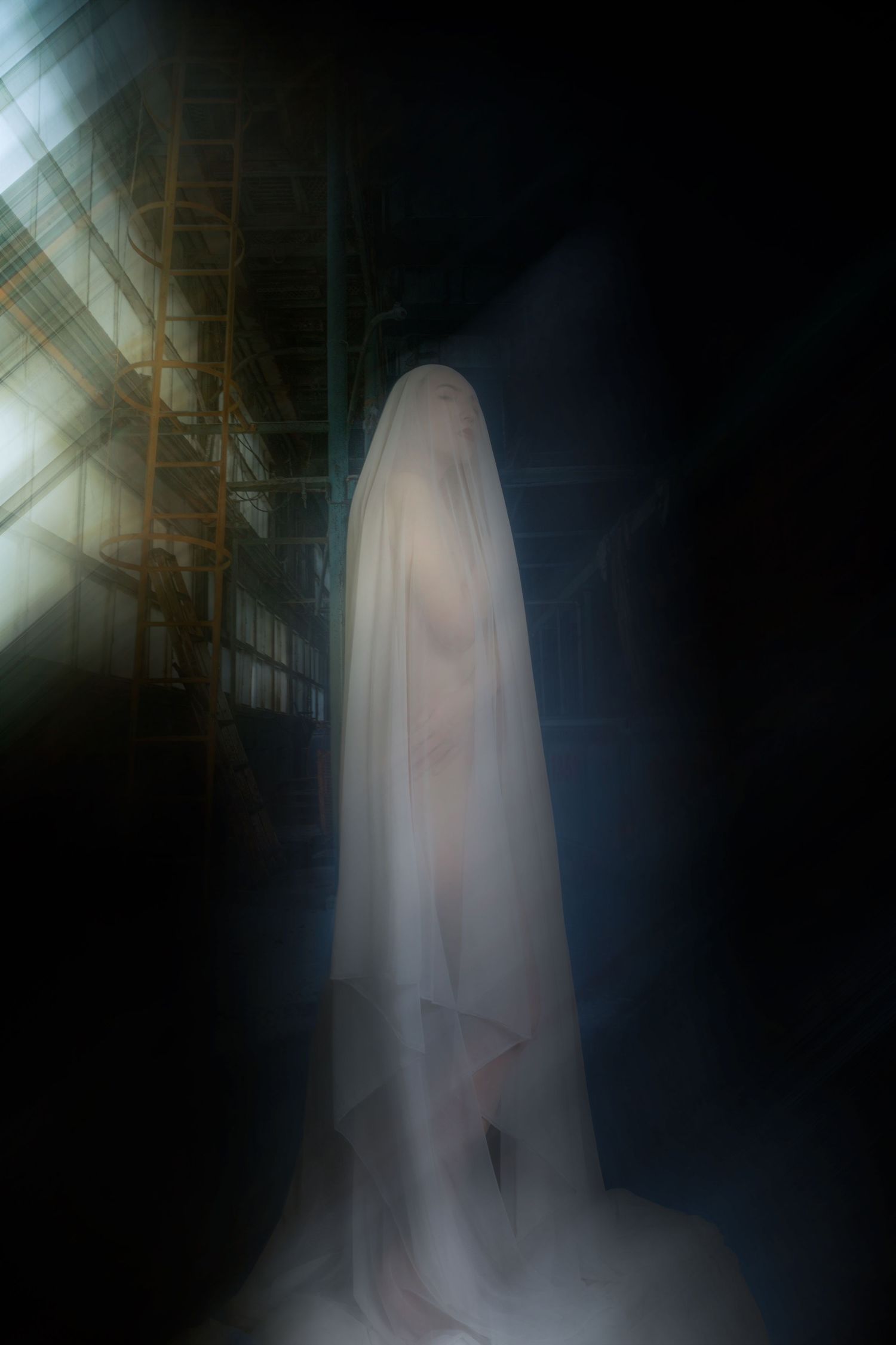 A ghostly figure draped in white fabric stands in a dark, atmospheric setting with dramatic light beams.