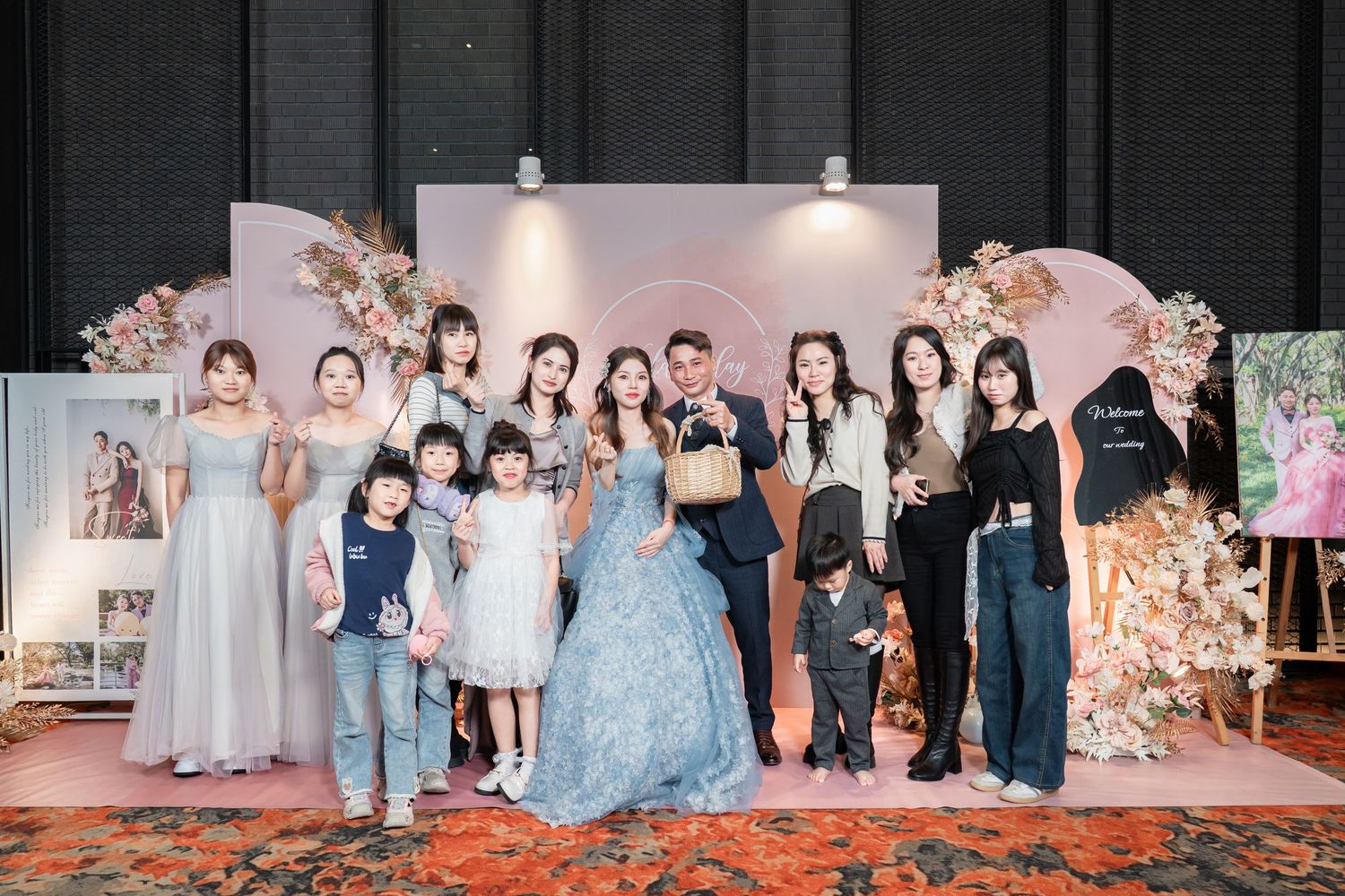 Group photos from a formal event showing people in elegant dresses and suits standing together on a stage.