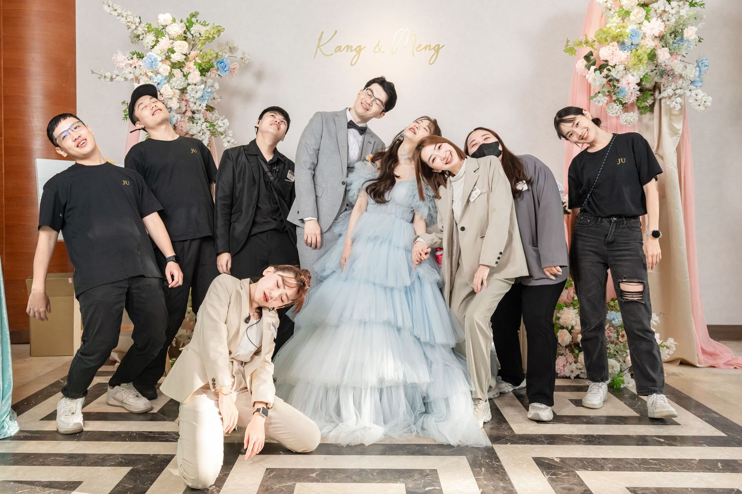 A wedding party poses together in a sequence of fun and playful group photos in a formal venue setting.
